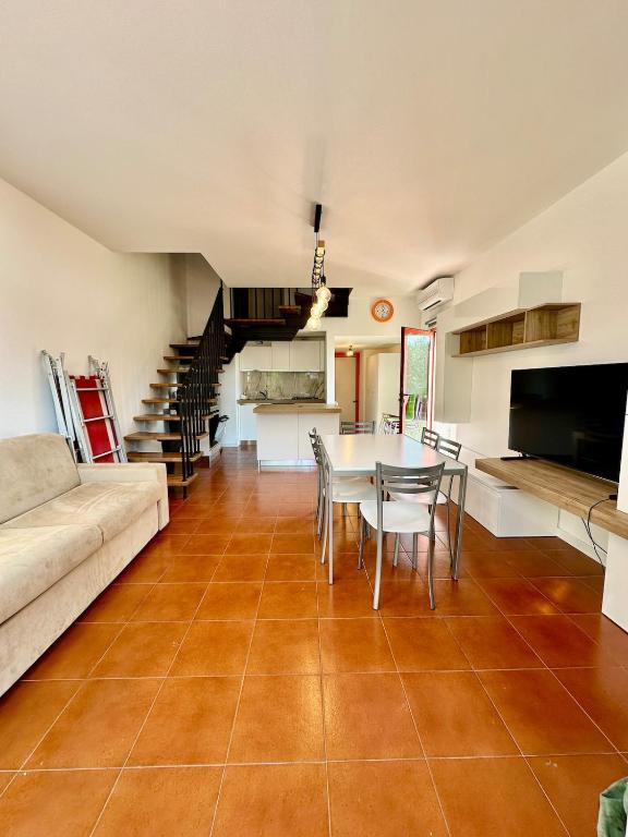 a living room with a couch and a table at Solleone 18 - Sea, Sun e Pool in Cavallino-Treporti