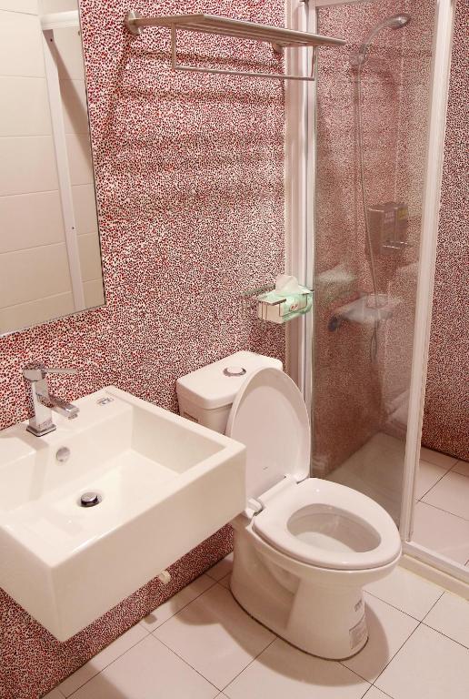 a bathroom with a toilet and a sink and a shower at Knock Knock Hostel in Kaohsiung