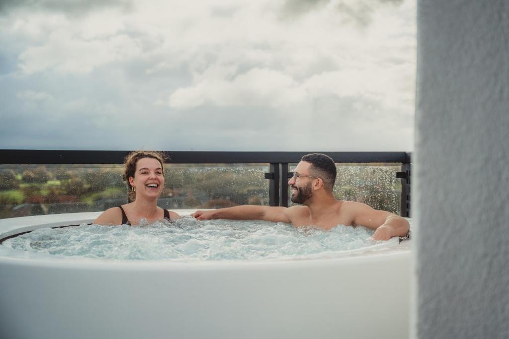 a man and a woman in a bath tub at Les Doms d'Alfred - AKWADOM in Ten Eiken