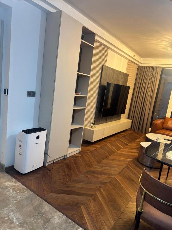 a living room with a television and a table at Executive Sky Residence in Skopje