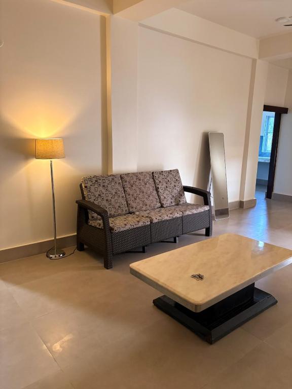 a living room with a couch and a coffee table at LN Homes in Itānagar