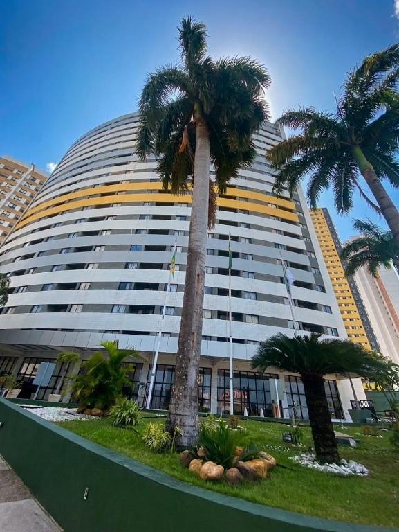 a large building with palm trees in front of it at Natal Plaza Hotel in Natal