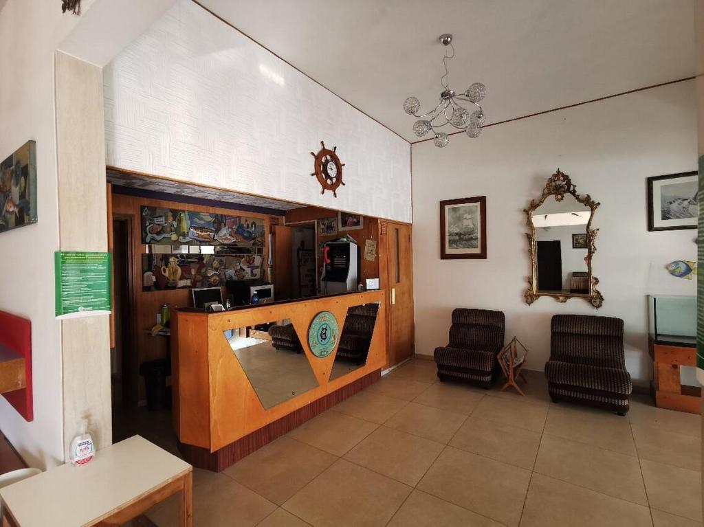 a living room with a desk and chairs in a room at Hotel Cristallo Cesenatico in Cesenatico