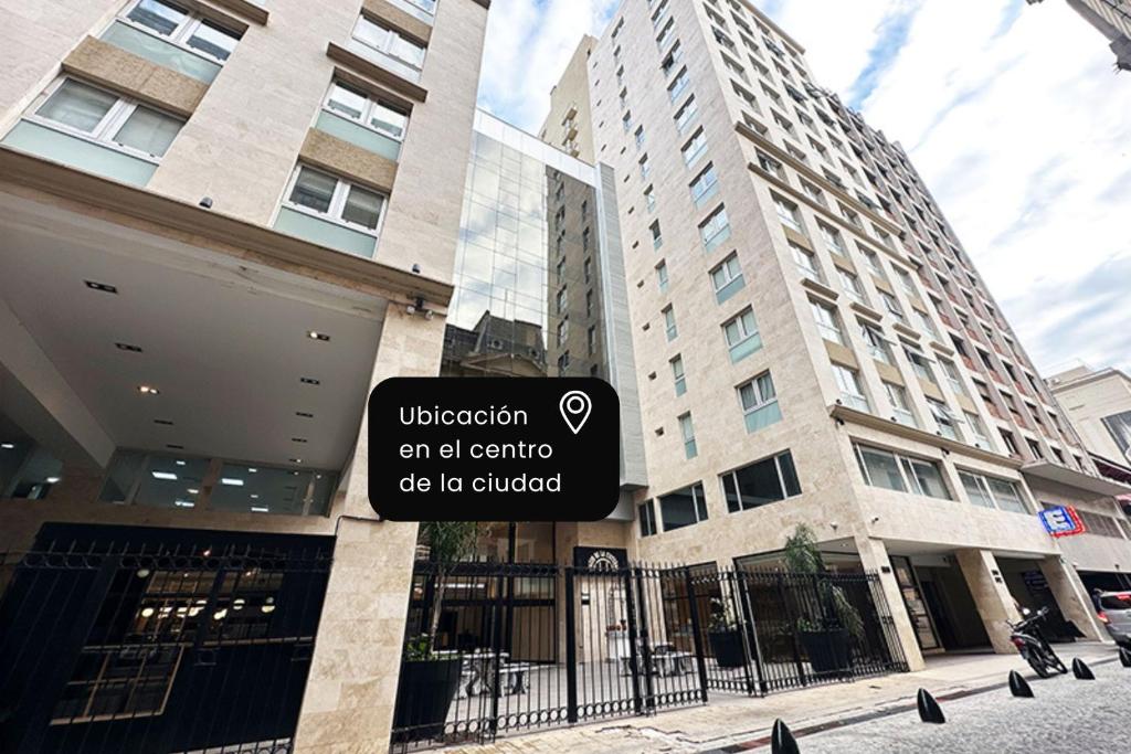 a sign in front of a building with a building at La Cisterna by DOT Suites in Buenos Aires