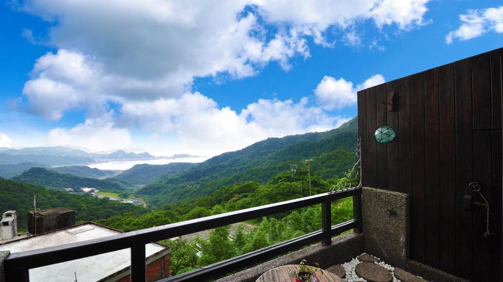 a view of a mountain valley from a balcony at Sunny Room in Jiufen