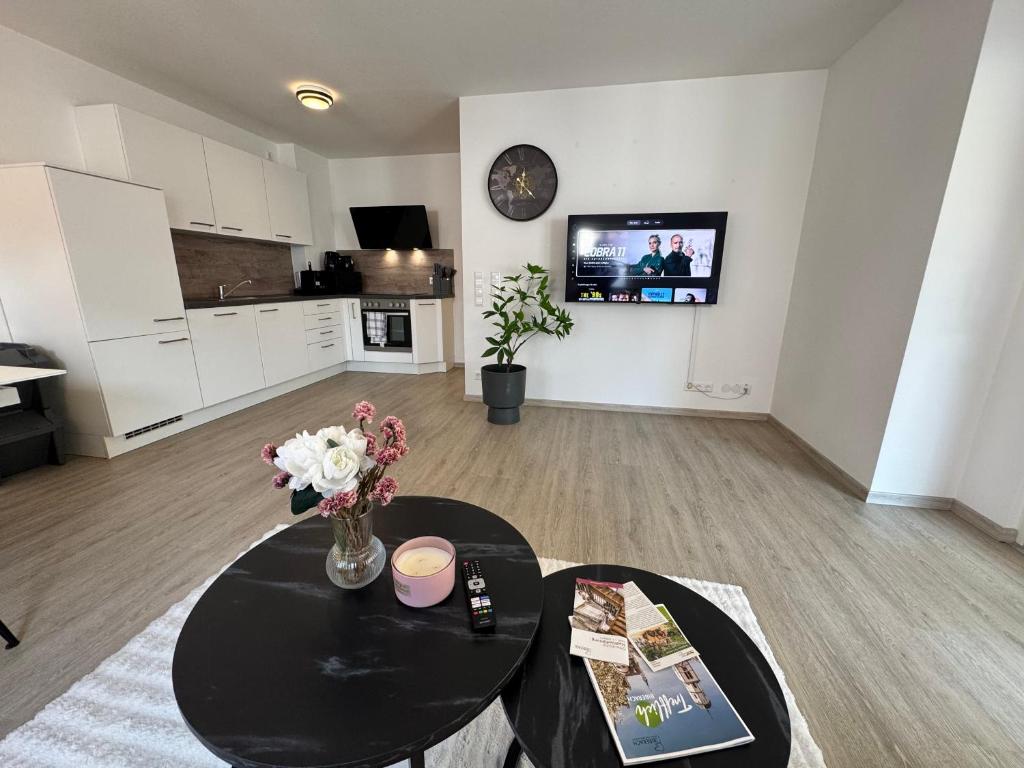 a living room with a table with flowers on it at Feel like Home 8 in Biberach an der Riß