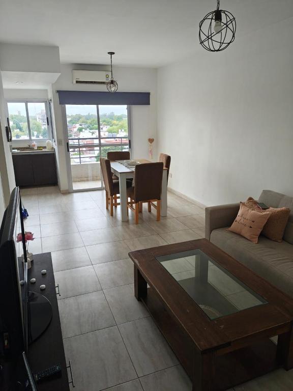 a living room with a couch and a table at Balcón de Lourdes in Santos Lugares