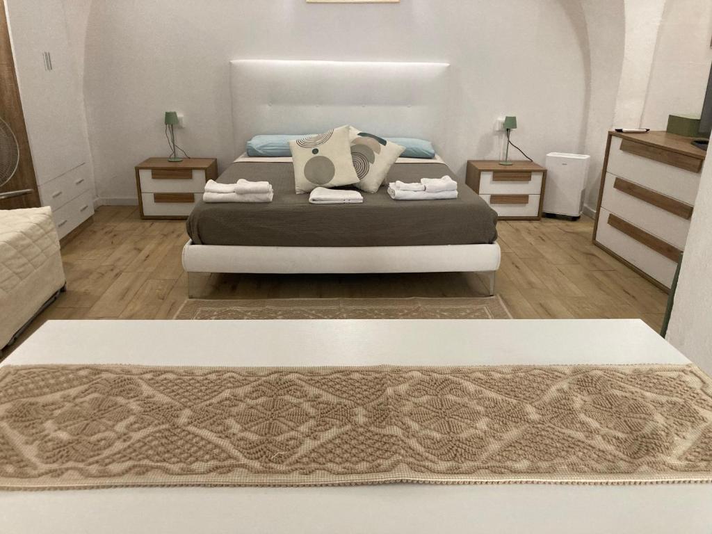 a bedroom with a bed and two night stands at F&F Room in Sassari