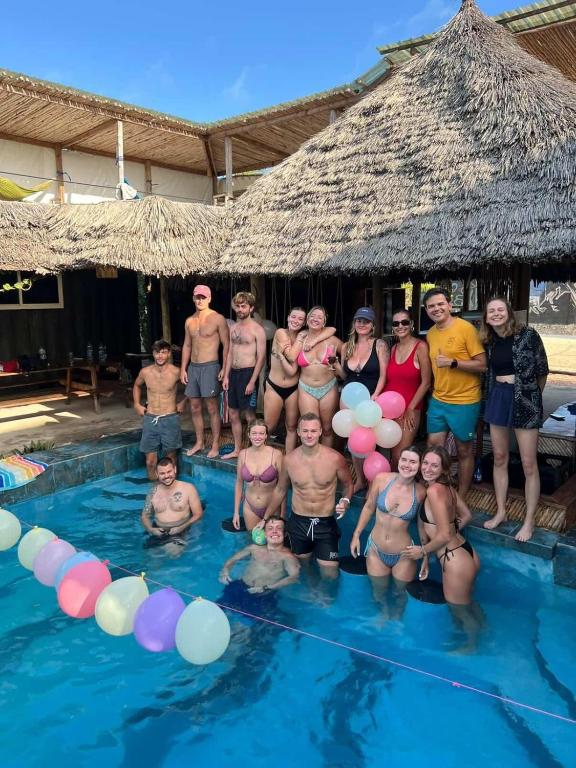 a group of people standing in a swimming pool at Jambiani Backpackers Hostel in Jambiani