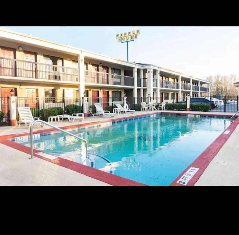 a large swimming pool in front of a hotel at Garden Inn Adairsville in Adairsville
