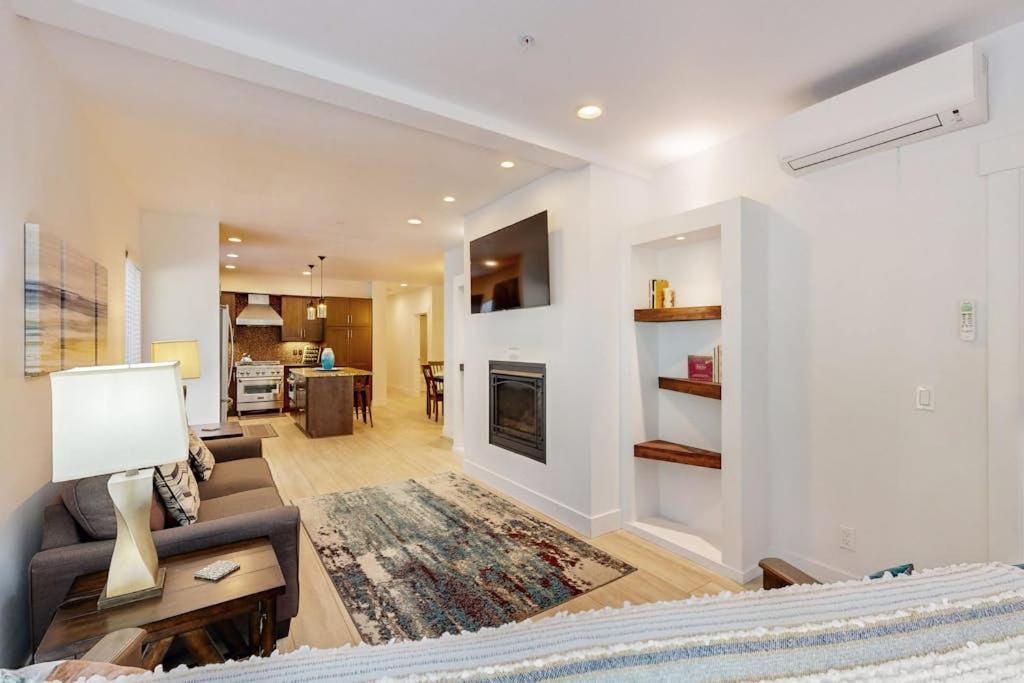 a living room with a couch and a fireplace at Stunner apt with fireplace grill partial ocean views & partial AC in Gold Beach