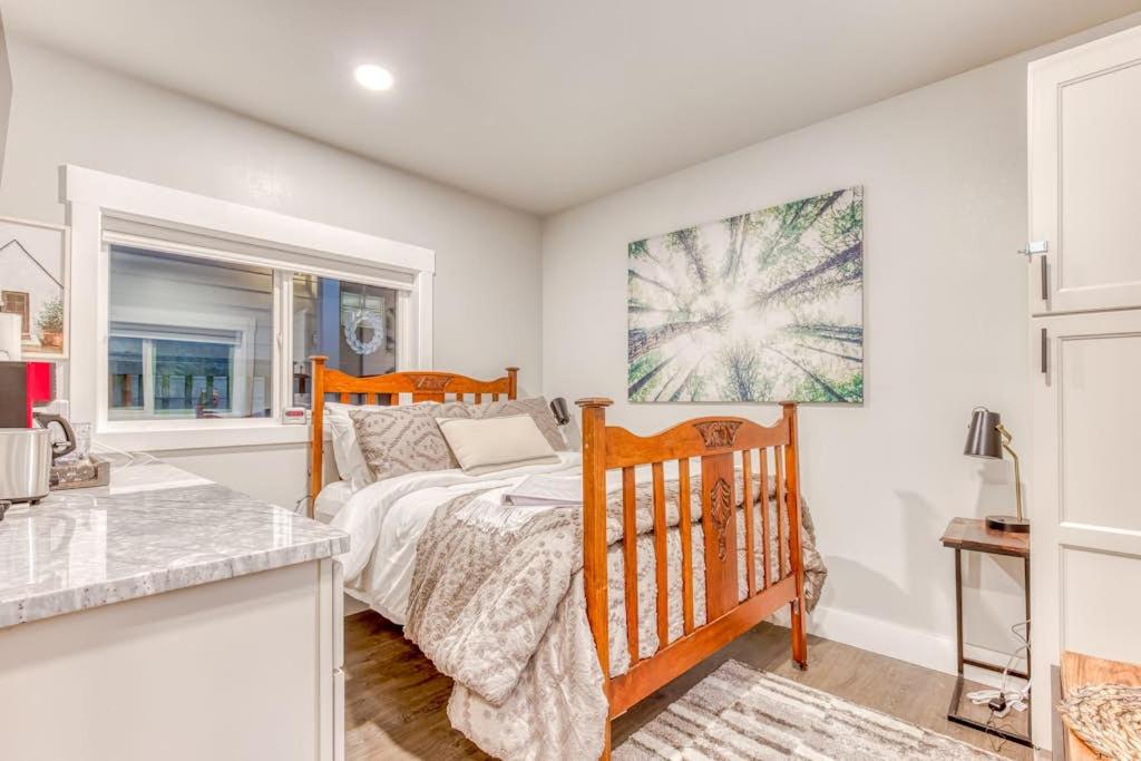 a bedroom with a bed and a window at Inviting studio with kitchenette & scenic forest setting in Welches