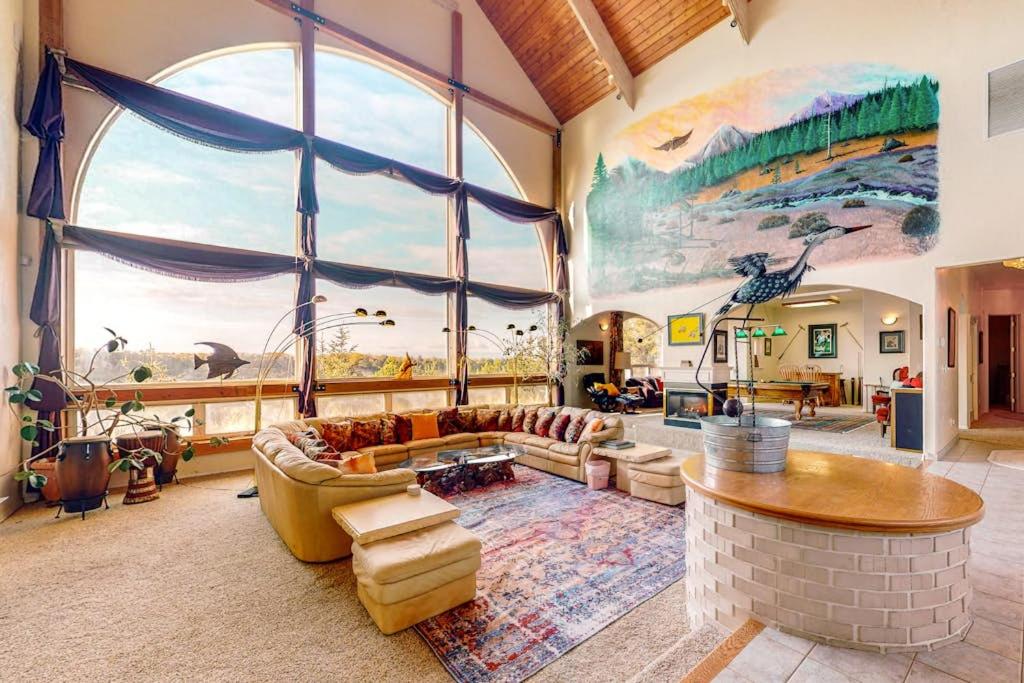 a large living room with a large window at Stunning Spacious Riverfront House with Private Sauna in Florence