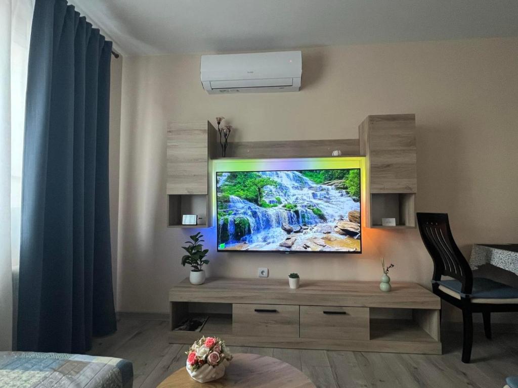 a living room with a flat screen tv on a wall at Topalov in Sandanski