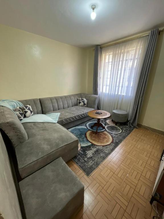 a living room with a couch and a table at Serenity villa homes in Nairobi