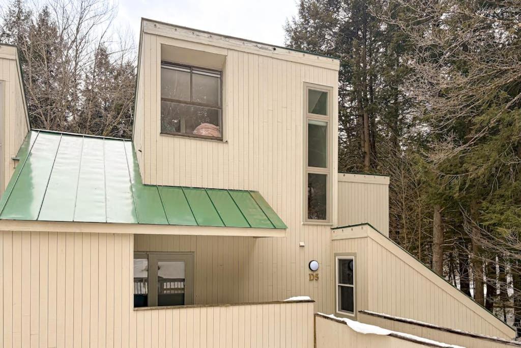 a house with a green roof and a window at Butternut Hill D5 in Waitsfield