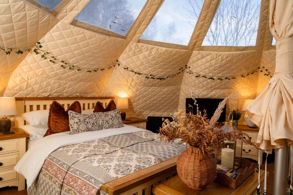 a bedroom with a bed in a tent at Stargazers in Norwich