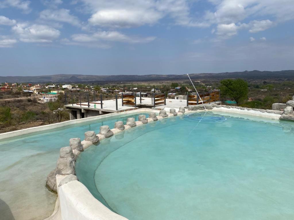 a large swimming pool with a view of a city at Complejo Las Carolina in Arroyo de Los Patos