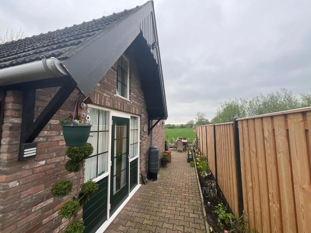 an awning on a house with a fence at Janka B&B in Elim