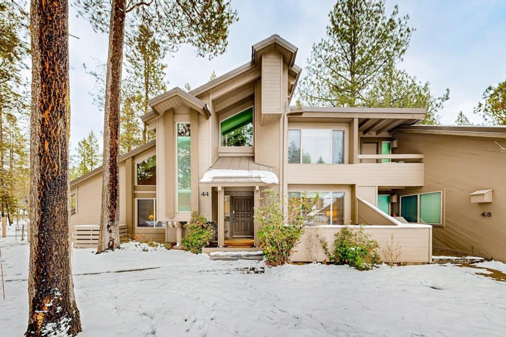 a house in the woods with snow at Comfortable condo with shared pool SHARC passes trails and more in Sunriver