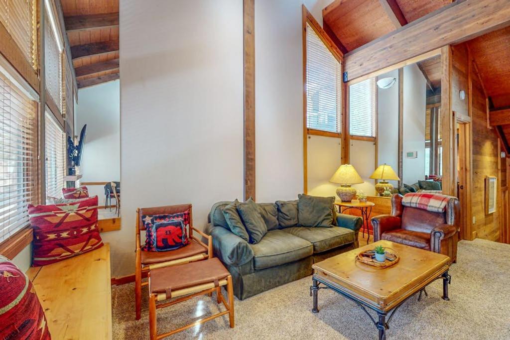 a living room with a couch and a table at Cozy condo with mountain views free shuttle & W&D in Ponderosa Fairway Estates