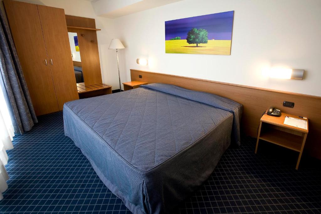 Postel nebo postele na pokoji v ubytování Hotel Gallia