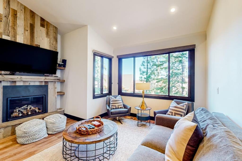 a living room with a couch and a fireplace at Ski and Ski Out Designer Condo With a View in Kingswood Estates