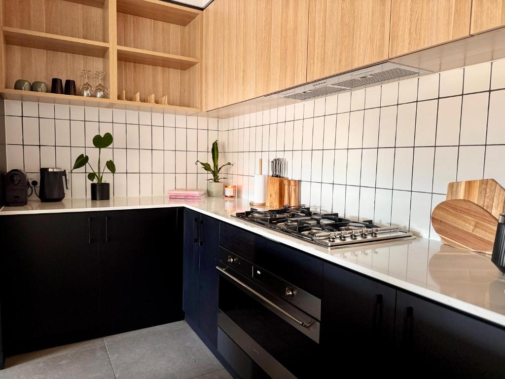 a kitchen with a stove and a counter top at Stylish Industrial City Retreat in Bowden