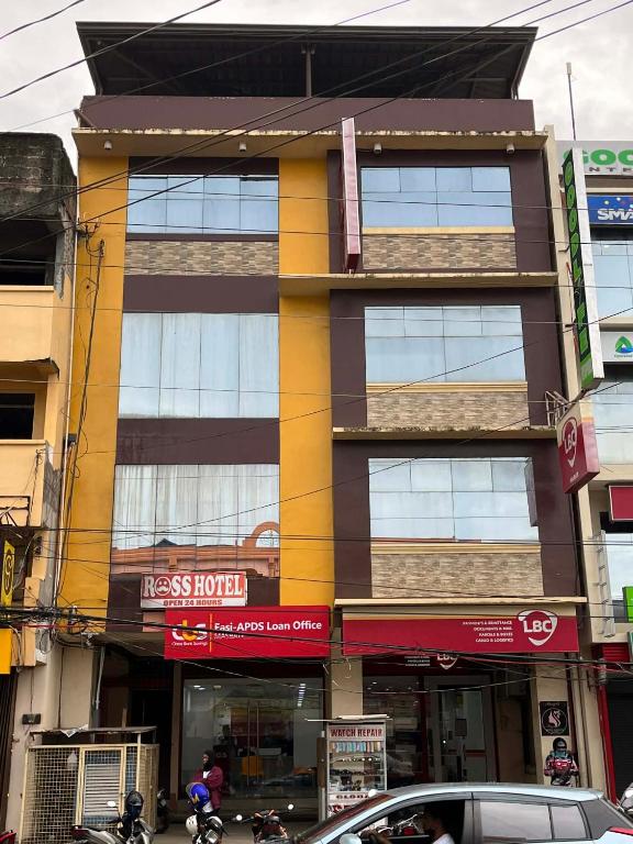 a building on a city street with motorcycles parked in front at RTRoss Hotel in Masbate