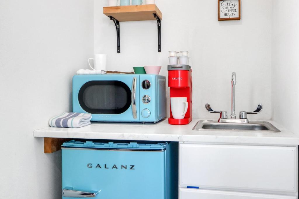 a kitchen counter with a microwave and a sink at The Container Retreat - 4B.. in Canyon Lake