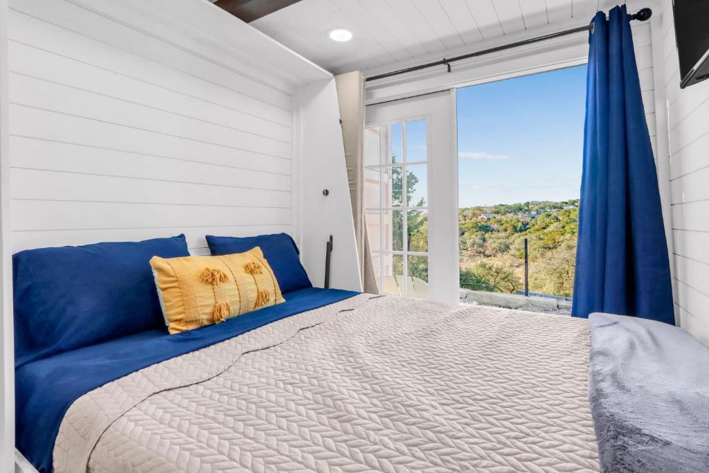 a bedroom with a large bed and a large window at The Container Retreat - C10 in Canyon Lake