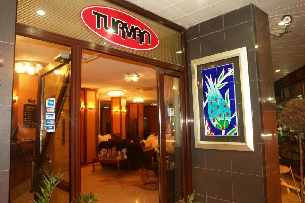 a restaurant with a sign on the side of a building at Turvan Hotel in Istanbul