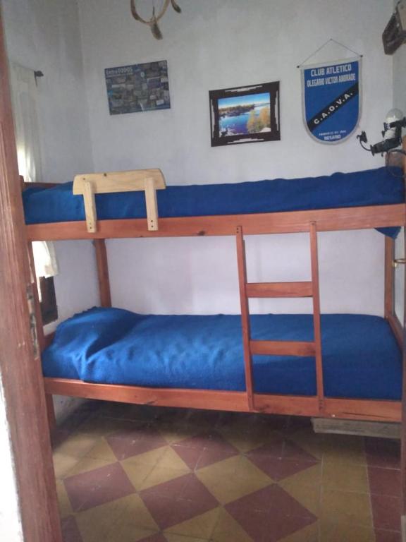 two bunk beds in a room with a blue mattress at Los cristales unquillo in Unquillo