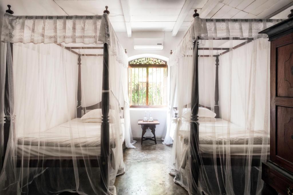 Postel nebo postele na pokoji v ubytování Nisala Arana Boutique Hotel