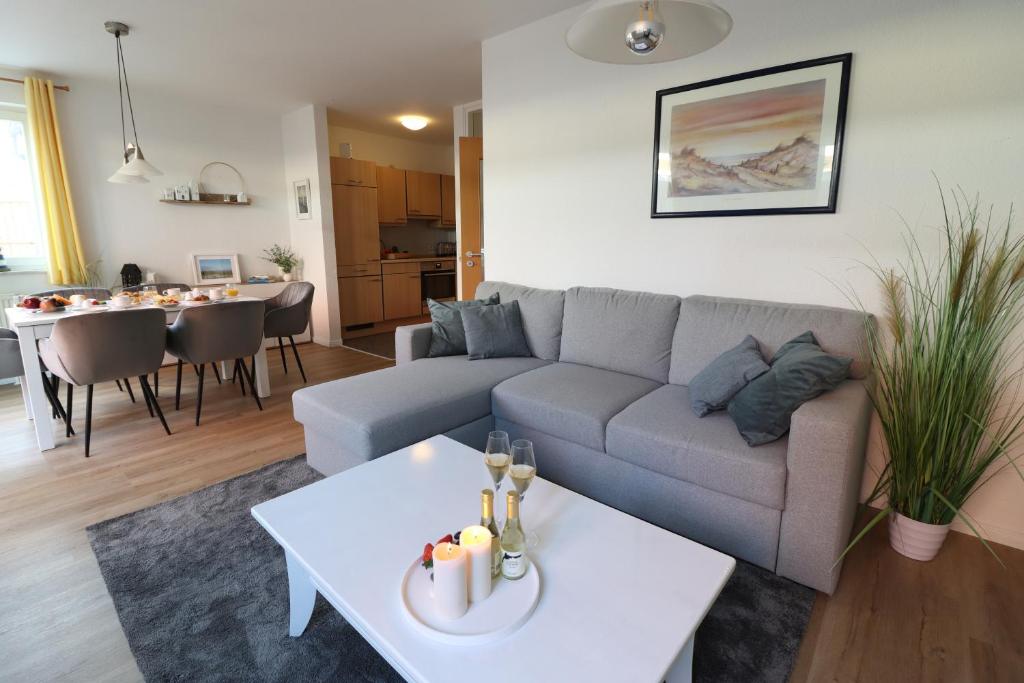 a living room with a couch and a table at Meeresrauschen 03 in Neuhaus
