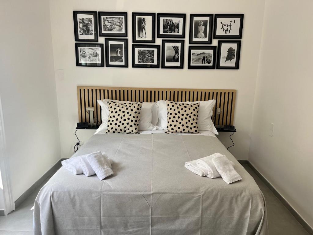 a bedroom with a large bed with two white pillows at iPrincipati Luxury Living Suite in Salerno