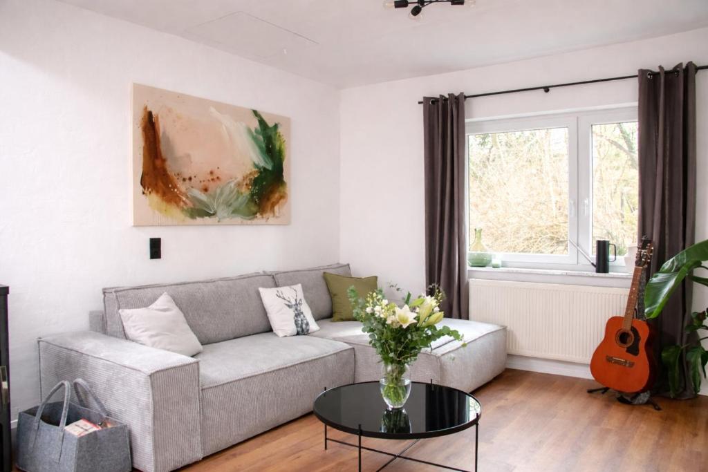 a living room with a couch and a table at Ferienhaus Wacholder in Mechernich