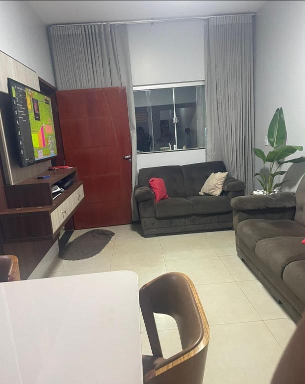 a living room with a couch and a television at Tecnoshow in Rio Verde
