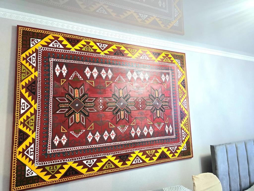 a tapestry hanging on a wall at Аэропорт-Астана двухкомнатная in Astana