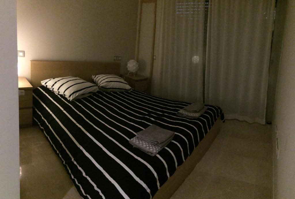 A bed or beds in a room at Villa Golf Las Colinas