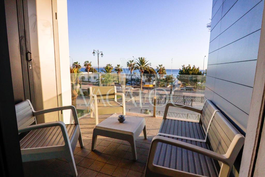 a balcony with two benches and a table with a view at Dassine View - Luxe - Agadir - 4 Px in Agadir
