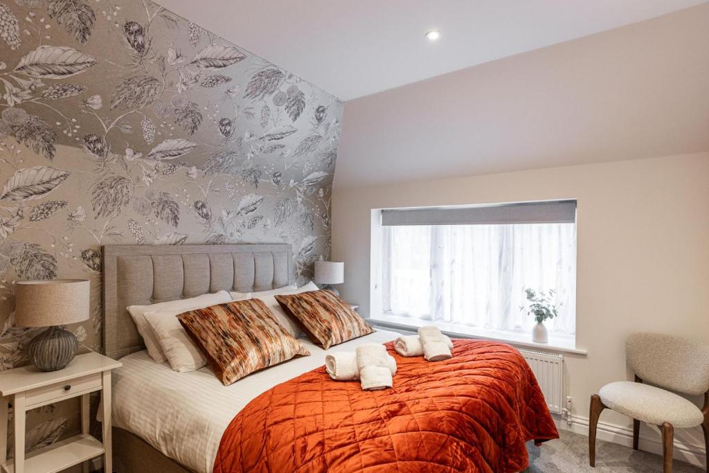 a bedroom with a bed with two towels on it at New Apartment in Guildford in Guildford
