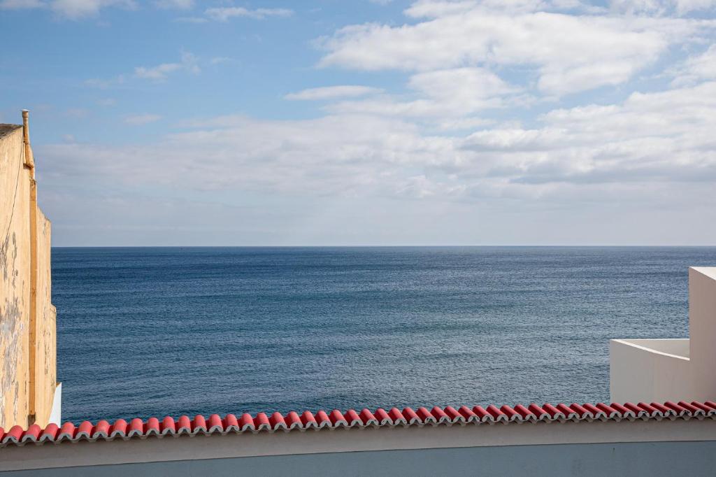 a view of the ocean from the roof of a building at GuestReady - Beachside house with ocean view in Ponta Delgada
