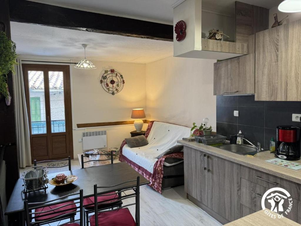 a kitchen with a bed in the corner of a room at Al clouc in CampÃ´me