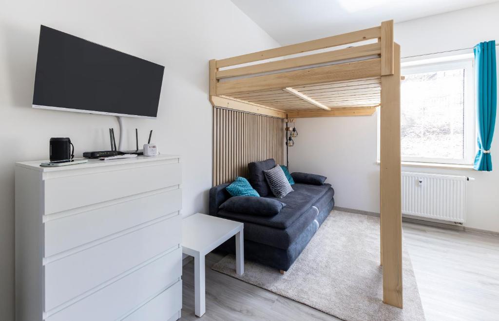 a living room with a couch and a loft bed at Apartmán Denisa in Rokytnice nad Jizerou