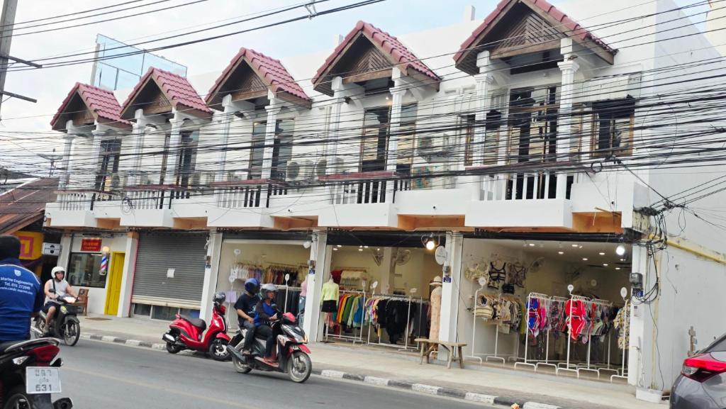 two motorcycles parked in front of a building at SUP Hometel Phuket in Ban Thalat Choeng Thale