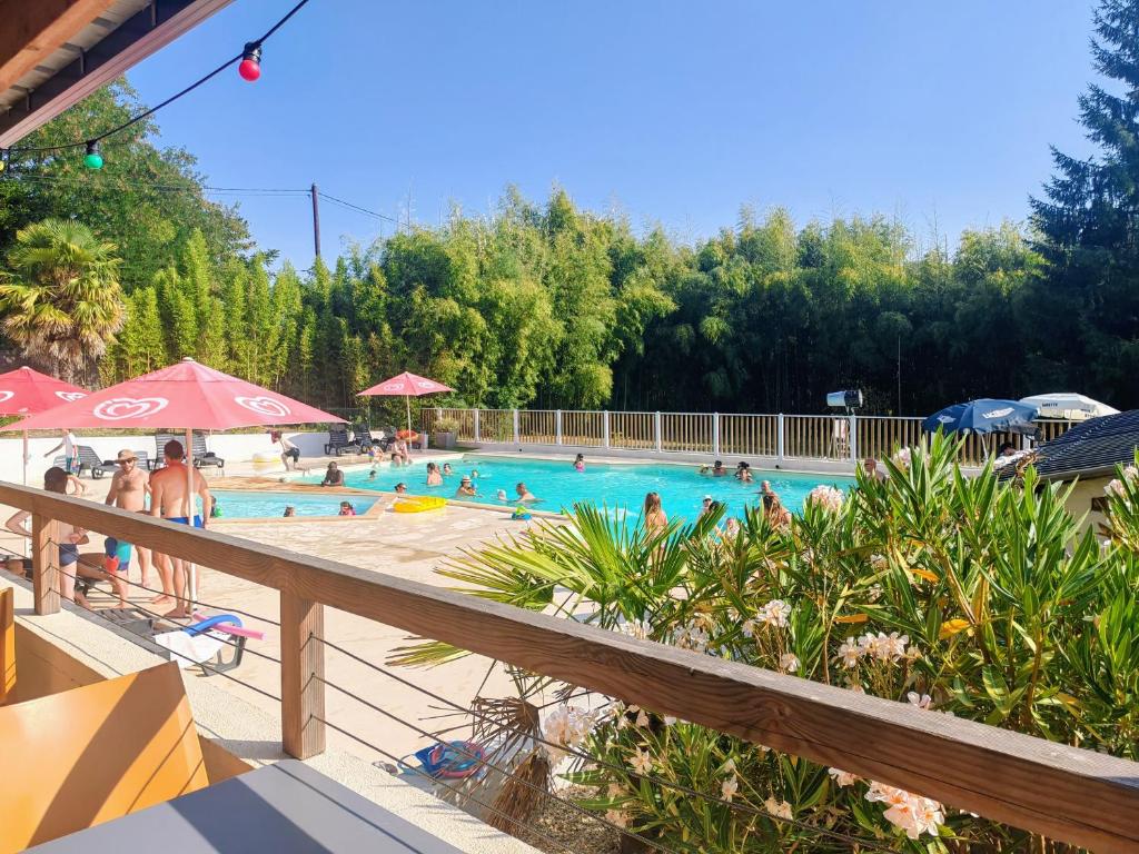 a large swimming pool with people in it at Camping L'oasis Du Berry - chalets climatisés in Saint-Gaultier