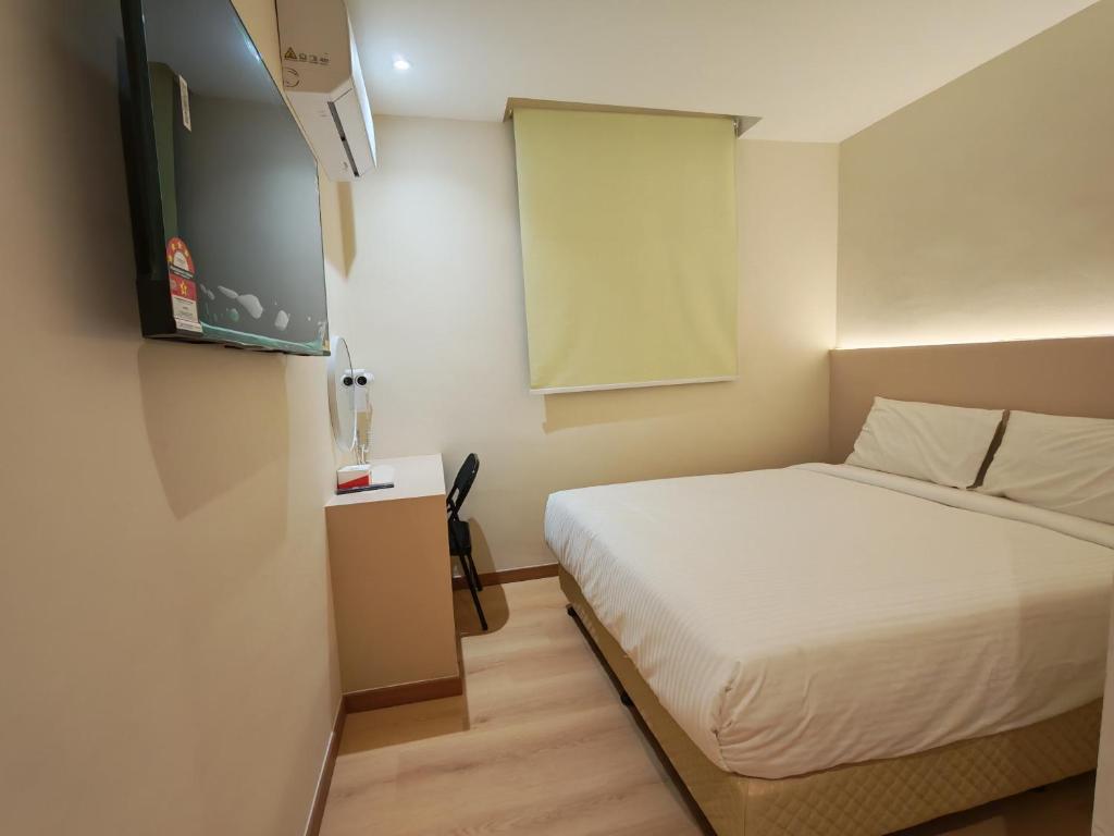 a small bedroom with a bed and a window at The Loft hotel 68 in Butterworth