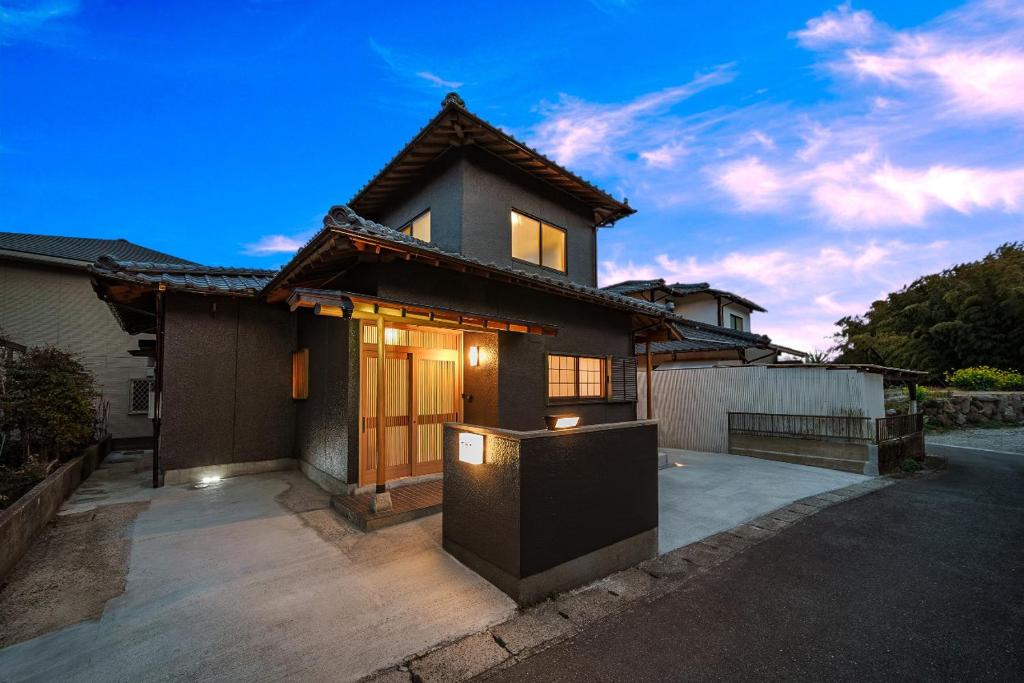 a house with a driveway in front of it at 夢思苑 別府 in Beppu