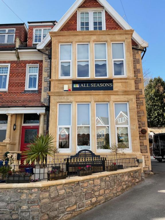a building with a sign that reads inn all seasons at All Seasons Bed & Breakfast - Adults Only in Weston-super-Mare